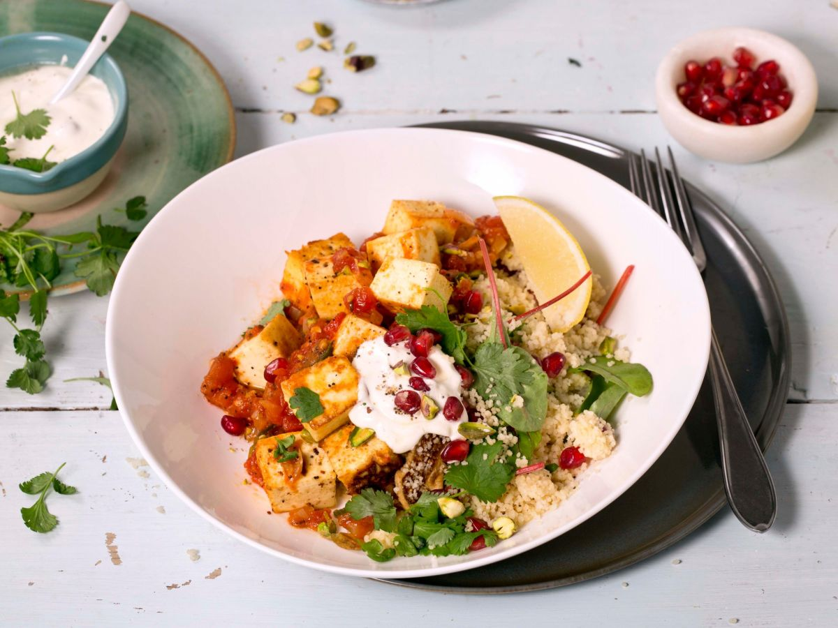 Paneer with couscous, greens and fresh garnish
